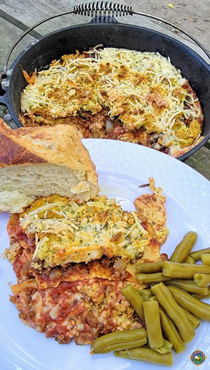 A serving of camping lasagna with green beans and some bread