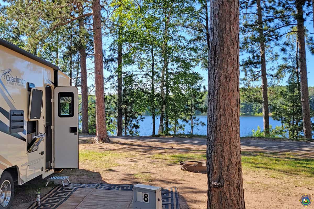 camper parked at a campsite overlooking a lake