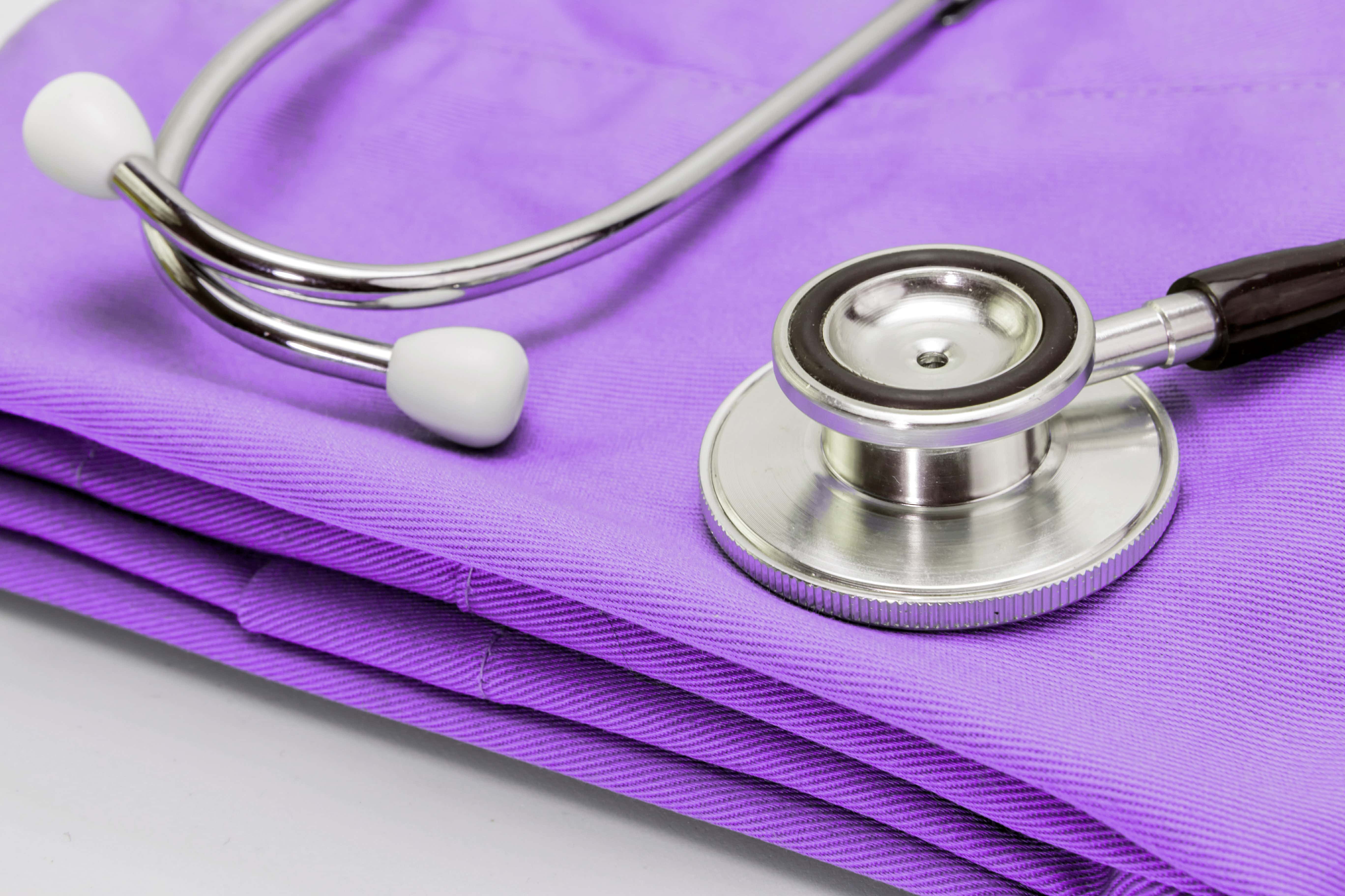 Stethoscope on clothes of nurse, conceptual image