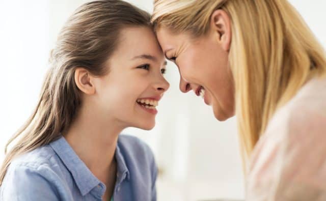happy smiling family of girl and mother at home