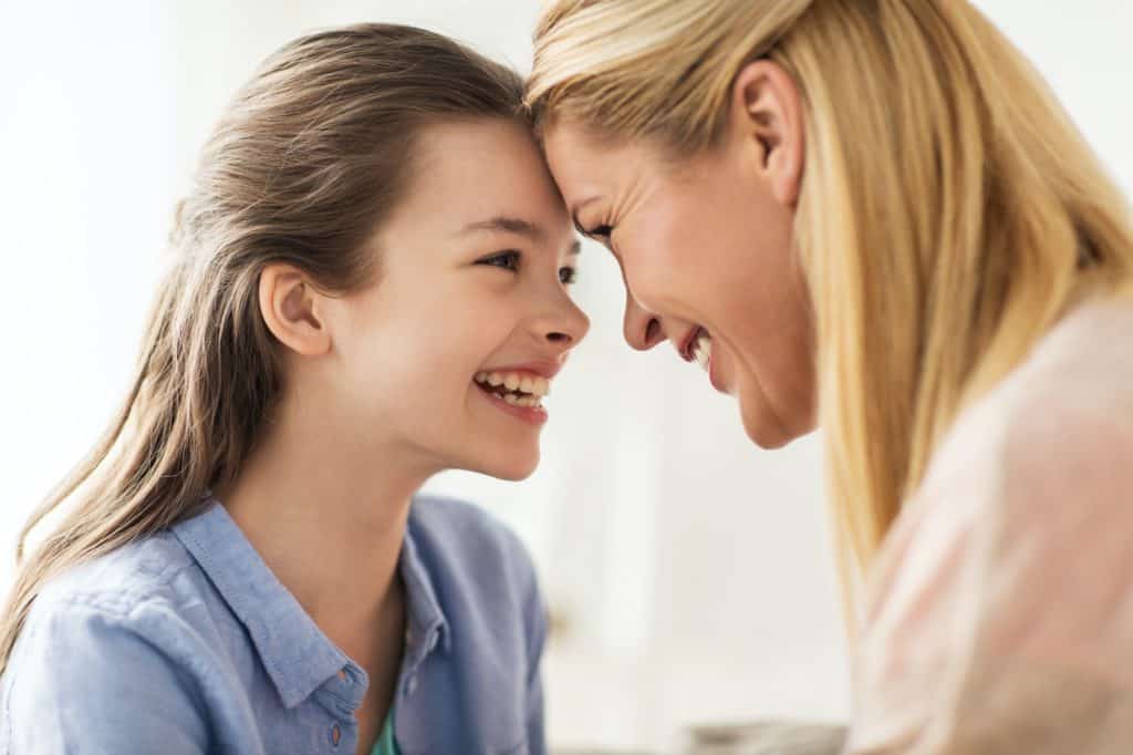 happy smiling family of girl and mother at home