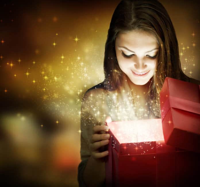 Christmas gifts miracle, woman open a gift box surprised and happy holiday glitter Christmas