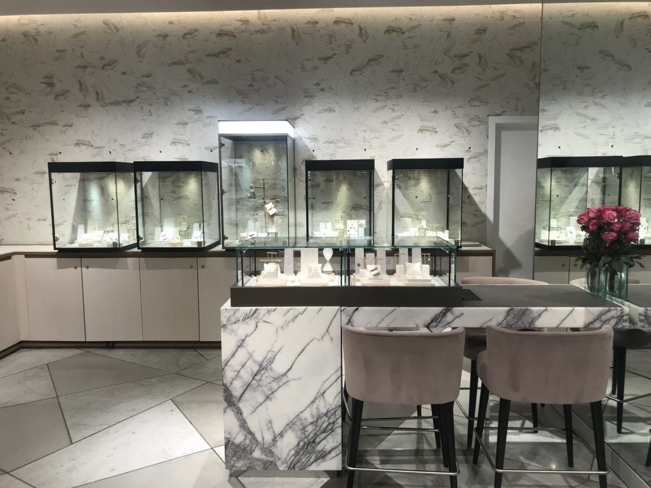 The Alkemistry store with glass displays, a table and chairs.