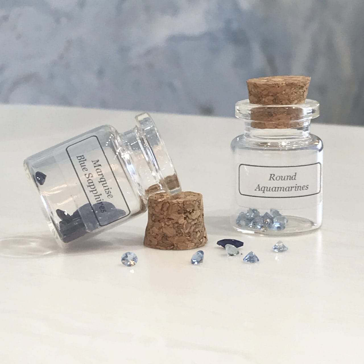 Two little decorative glass vials.