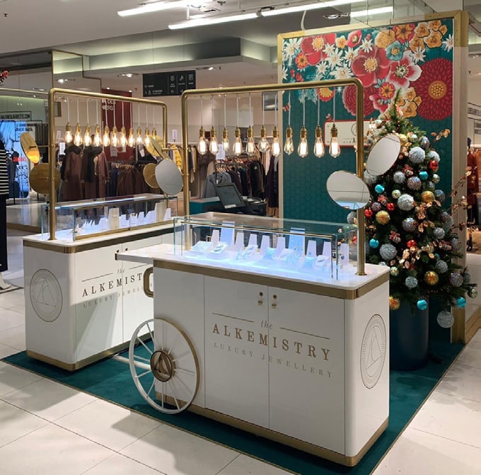 The Alkemistry store with glass displays and a christmas tree in the background.