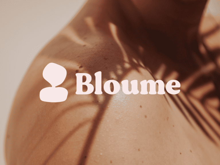 Close-up of a persons shoulder with soft lighting creating gentle plant shadows. The word Bloume is prominently displayed in white text. The skin looks smooth and natural, highlighted by subtle lighting effects.