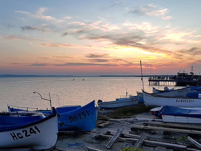 A serene sunset at Pomorie with several small fishing boats.