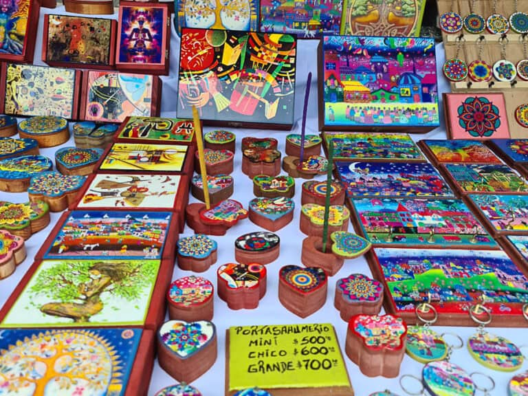 A colorful collection of hand-painted wooden crafts, including boxes, keychains, and coasters, showcasing traditional Argentine art and culture. Perfect souvenirs to bring home from Argentina.