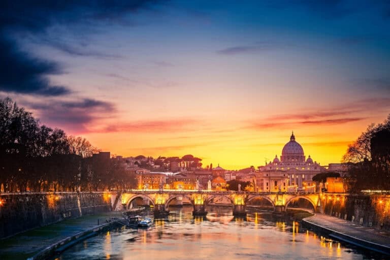 Stunning sunset view of St. Peter's Basilica and Ponte Sant'Angelo, a magical perspective often overlooked in Rome's bustling cityscape.