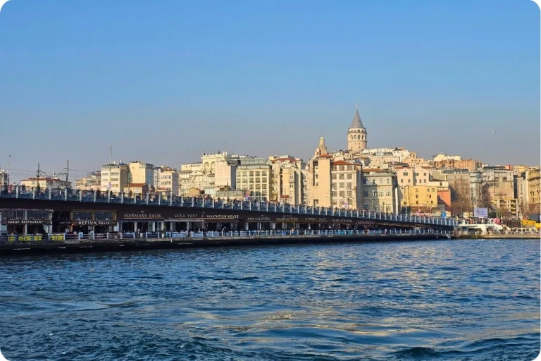 The iconic Galata Bridge in Istanbul, with the Galata Tower in the background, connecting travelers to the historic and modern parts of the city.