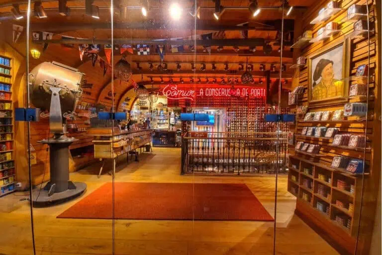 Rustic sardine shop in Lisbon filled with rows of colorful tinned fish and maritime decor—an iconic place to find quirky Portuguese sardine souvenirs.