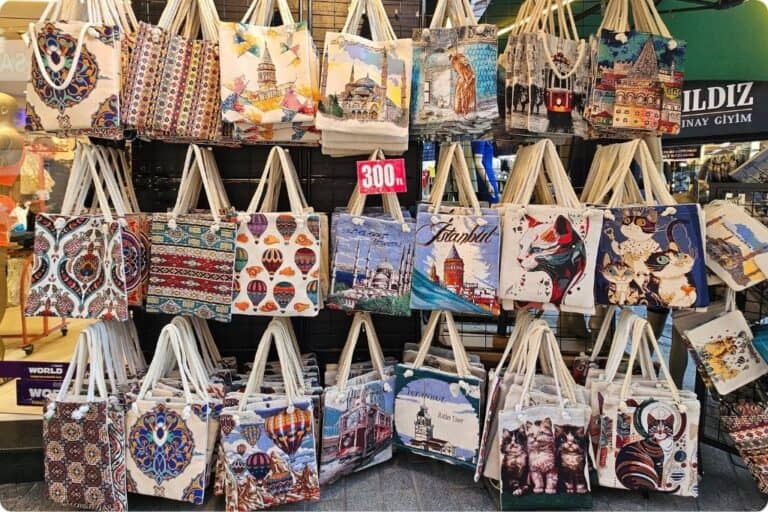 Colorful display of Turkish-themed tote bags featuring designs of Istanbul landmarks, Cappadocia hot air balloons, and traditional motifs, perfect as practical and artistic souvenirs from Turkey.