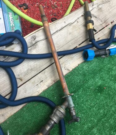leaking outdoor faucet plumber on the phone