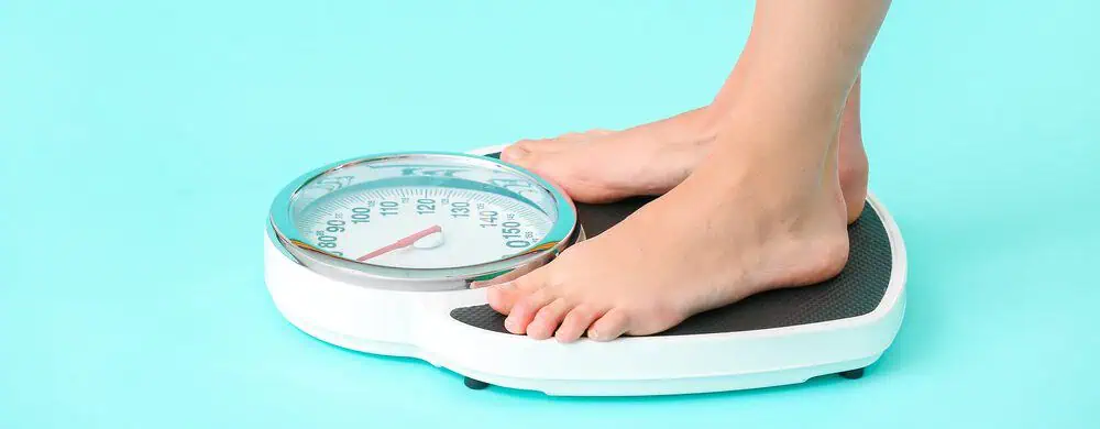 A woman standing on a weight scale