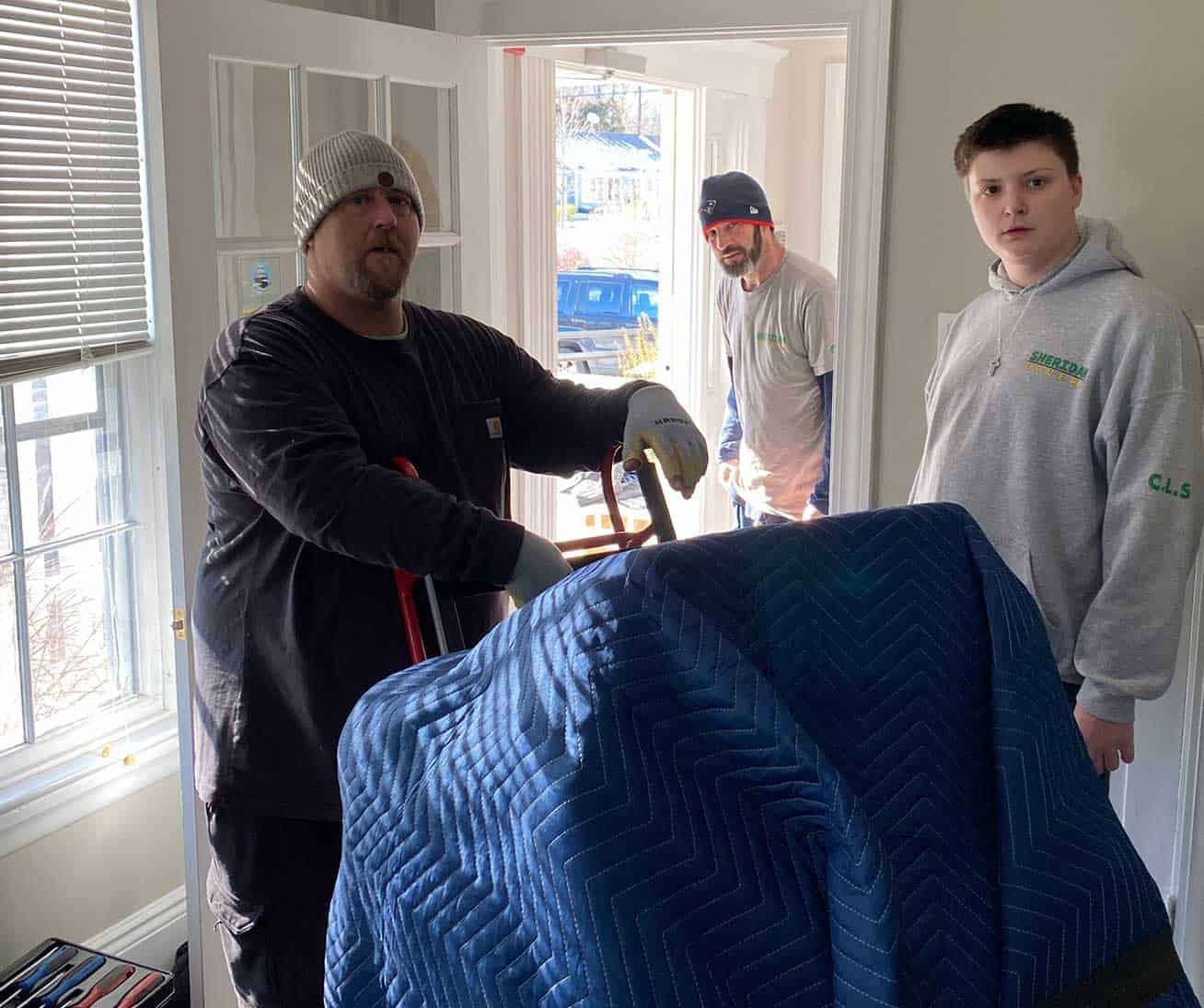 Sheridan Movers team in a client's house preparing items for move
