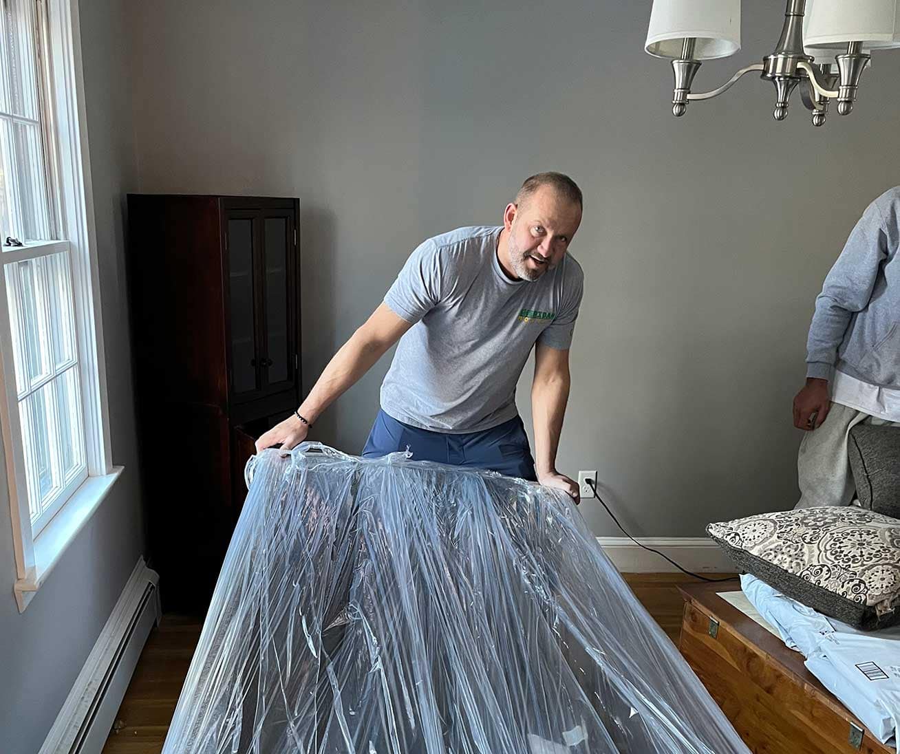 A member of Sheridan Movers wrapping an item up for a secure move