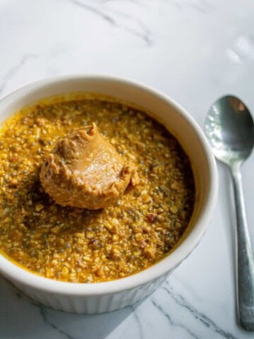 vegan pumpkin overnight oats in a bowl with peanut butter
