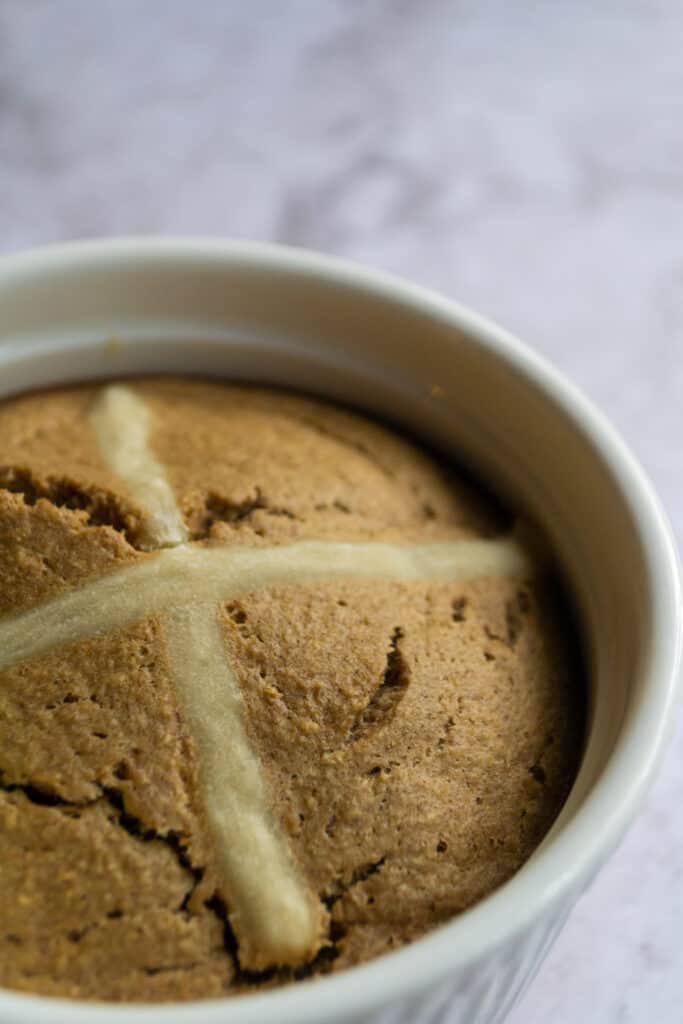 Side view of hot cross bun baked oats in a ramekin.