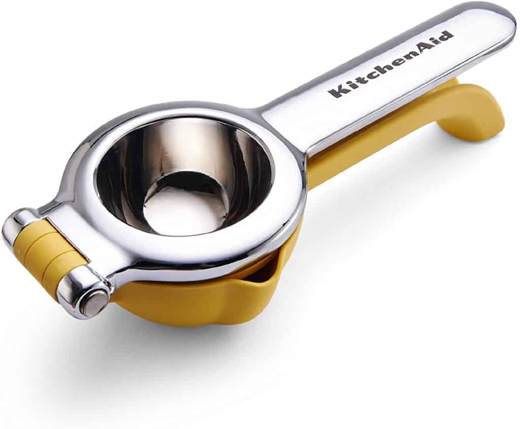 Product shot of a yellow KitchenAid citrus squeezer on a white background. 