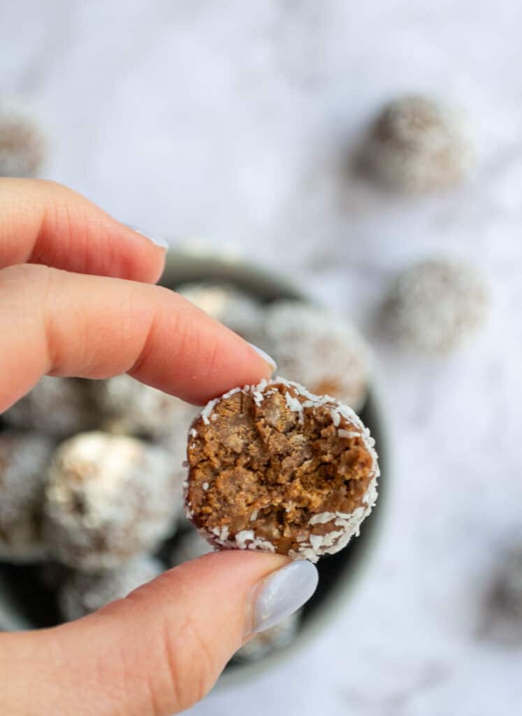 Easy Tim Tam ball with a a bite taken out of it.