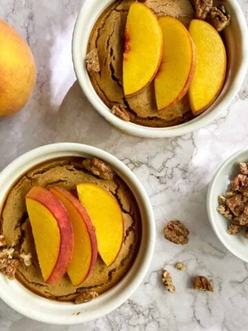 Two ramekins of peach baked oatmeal.