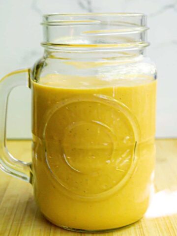 Pumpkin pie smoothie in a jar glass.
