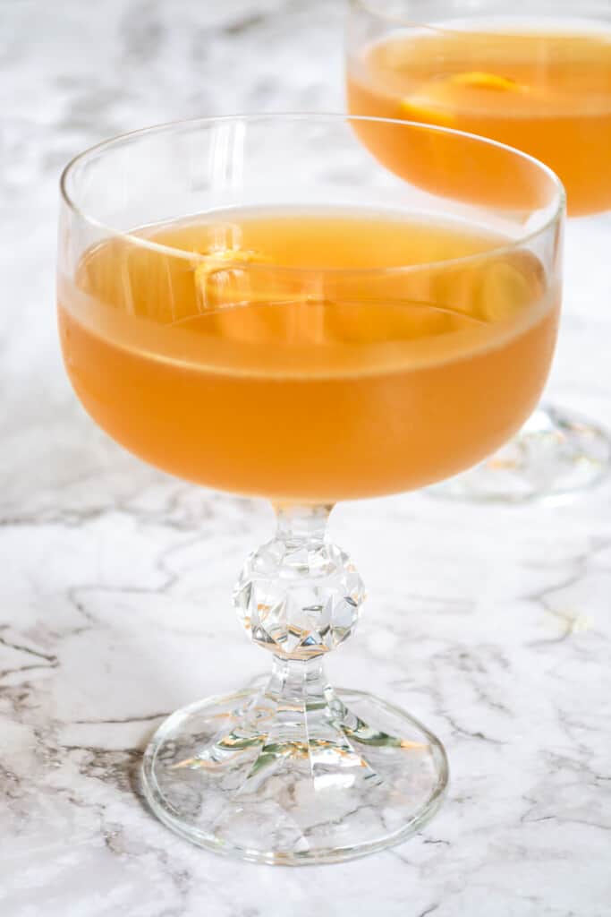 Closeup of a grapefruit daiquiri in a crystal cocktail glass.