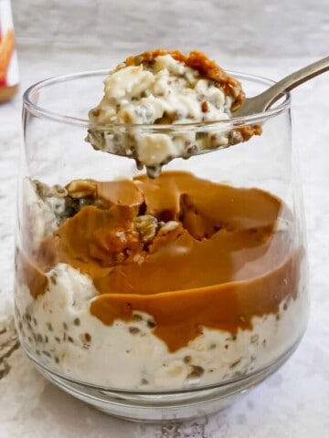 A spoon picking up a bite of overnight oats.