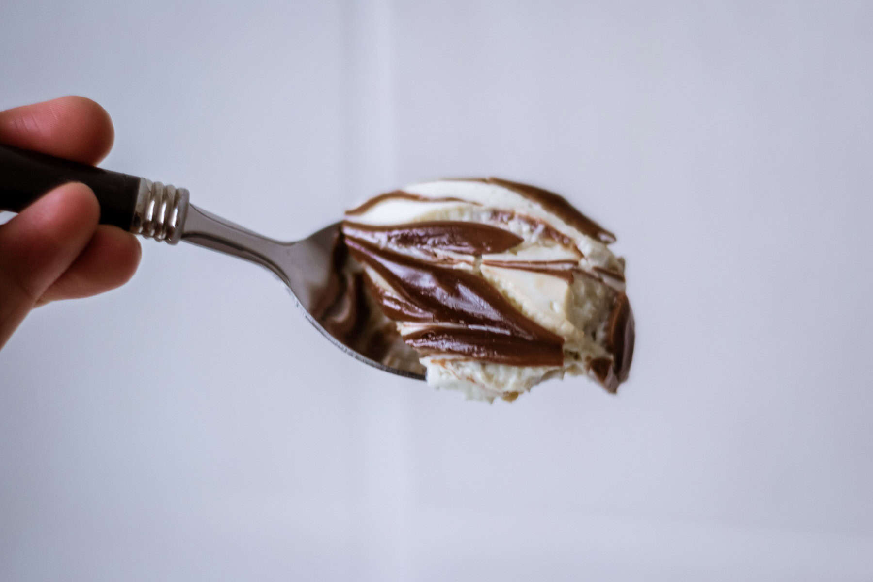 Detail shot of a bite of Nutella overnight weetabix on spoon close up.