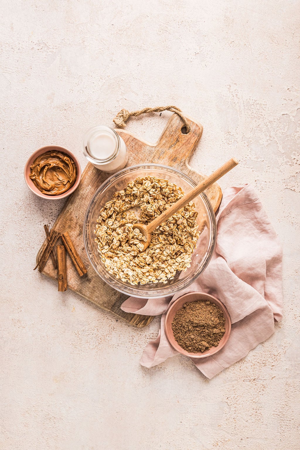 Overhead view of Biscoff overnight oats ingredients including milk, oats, Biscoff and cinnamon.