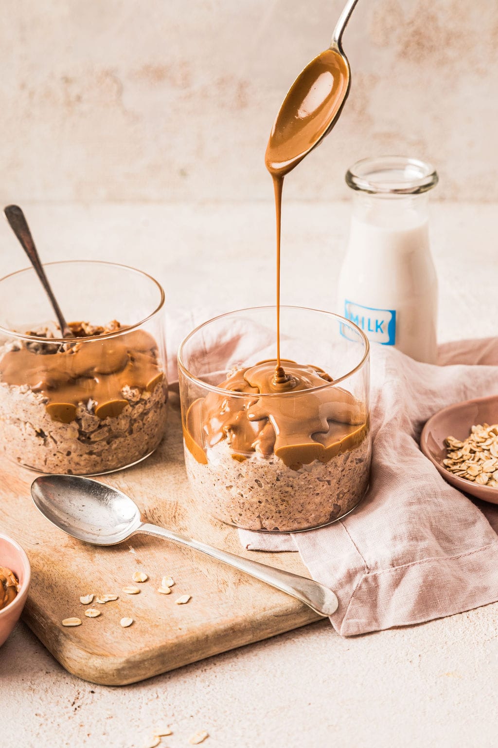 Front view of Biscoff overnight oats, with a drizzle of Biscoff pouring on top.