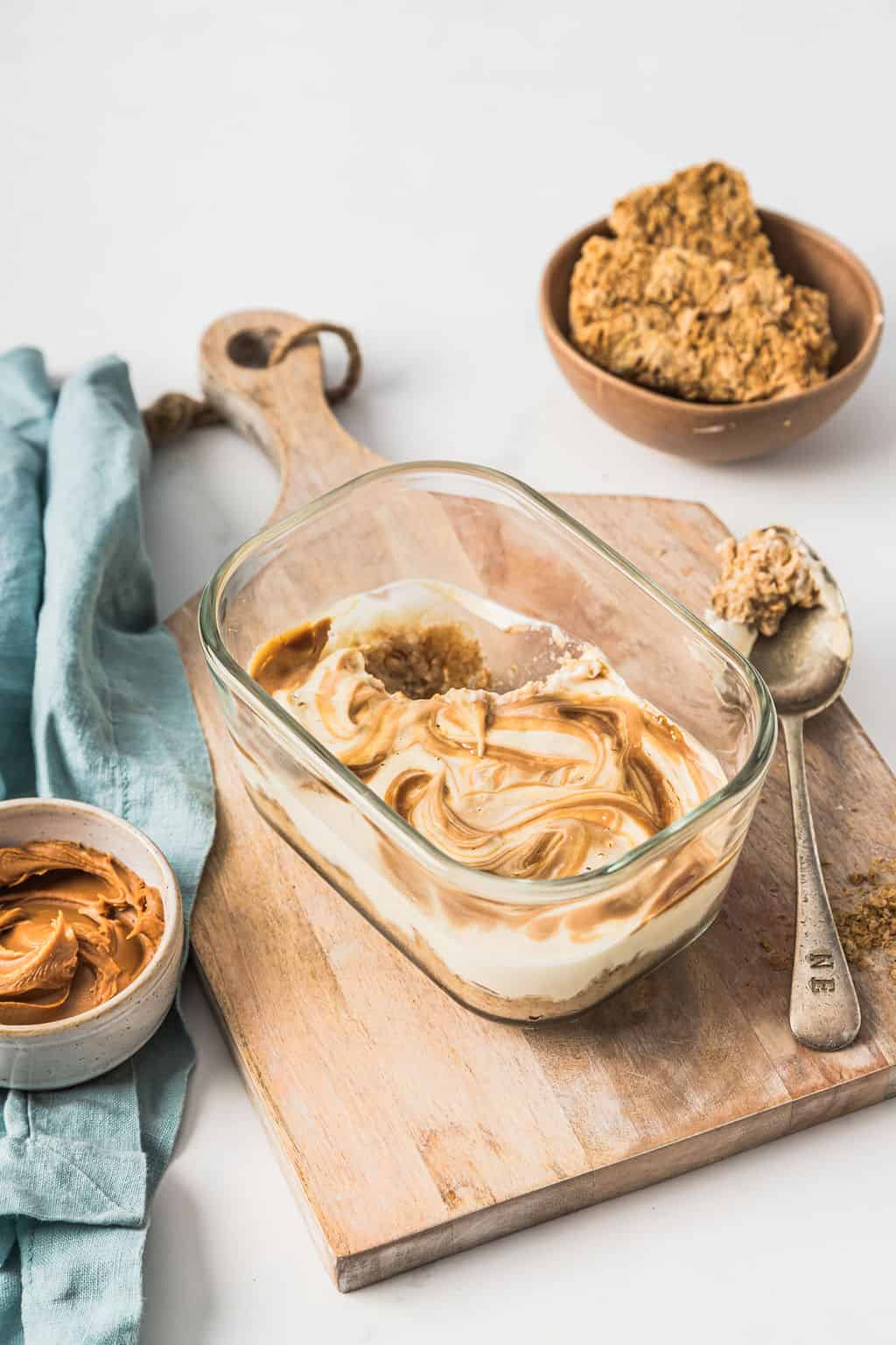 Angled front view of overnight weetabix with a Biscoff swirl in a glass meal prep container.