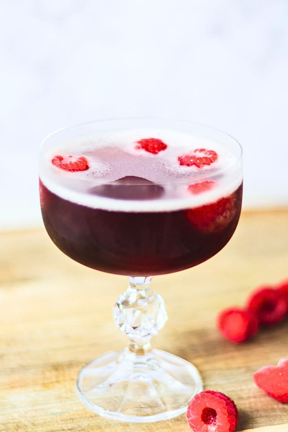 Front view of Kir Royale cocktail in a crystal coupe glass.