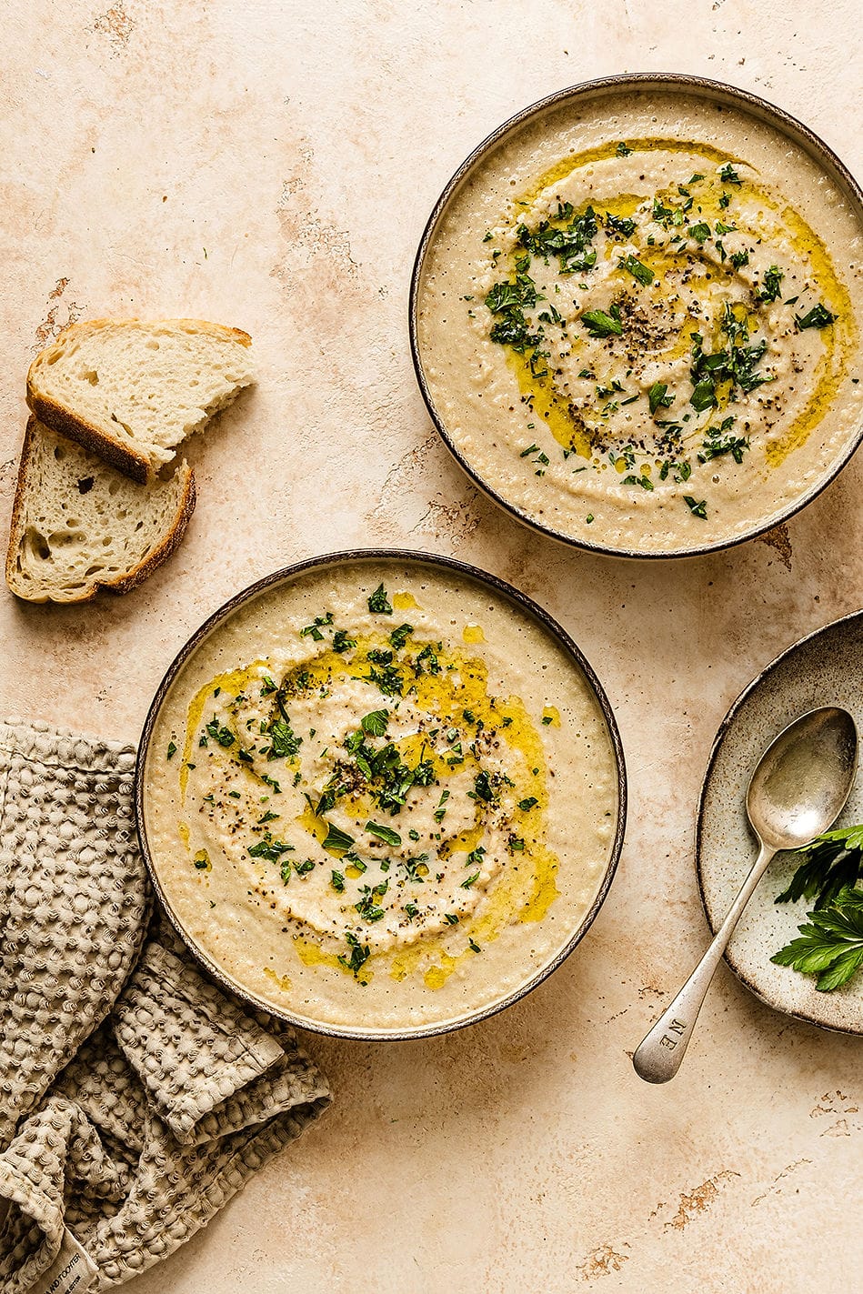 Overhead shot of two bowls of soup with bread.