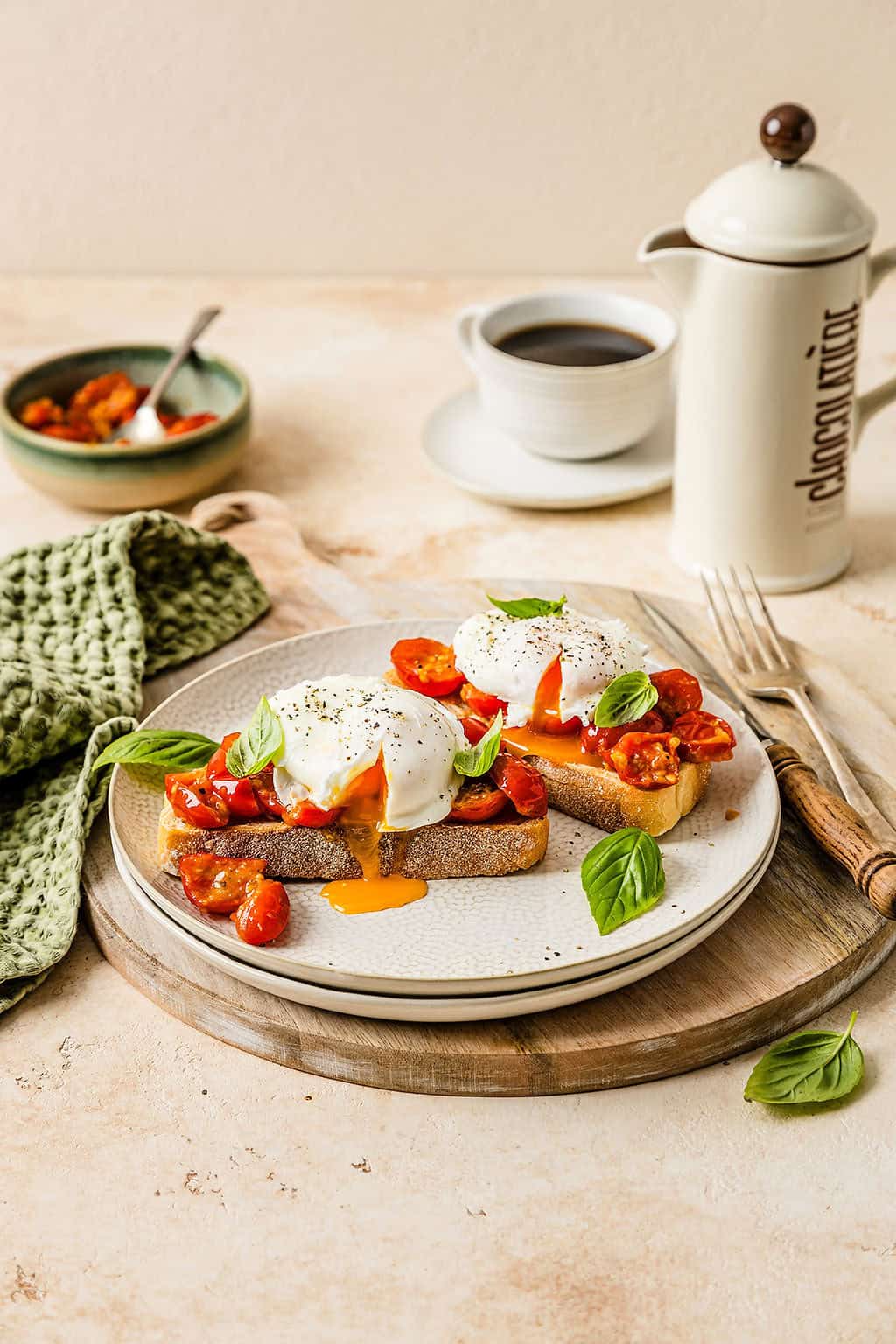 Close up showing Breakfast bruschetta on a plate, topped with a runny poached egg.