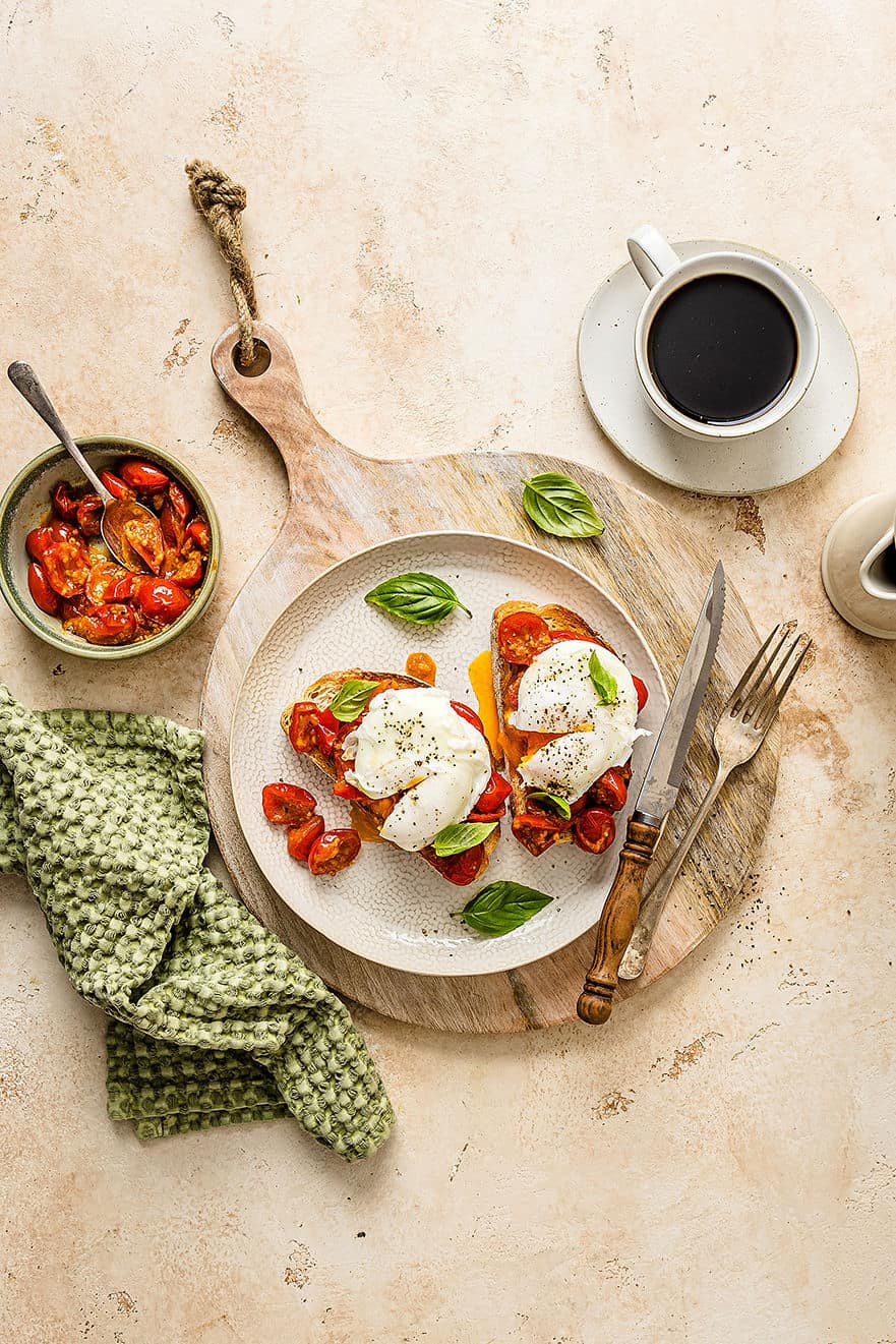 Overhead shot of breakfast bruschetta on a plate with poached eggs.