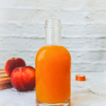 Pinterest pin featuring a bottle of peach syrup.
