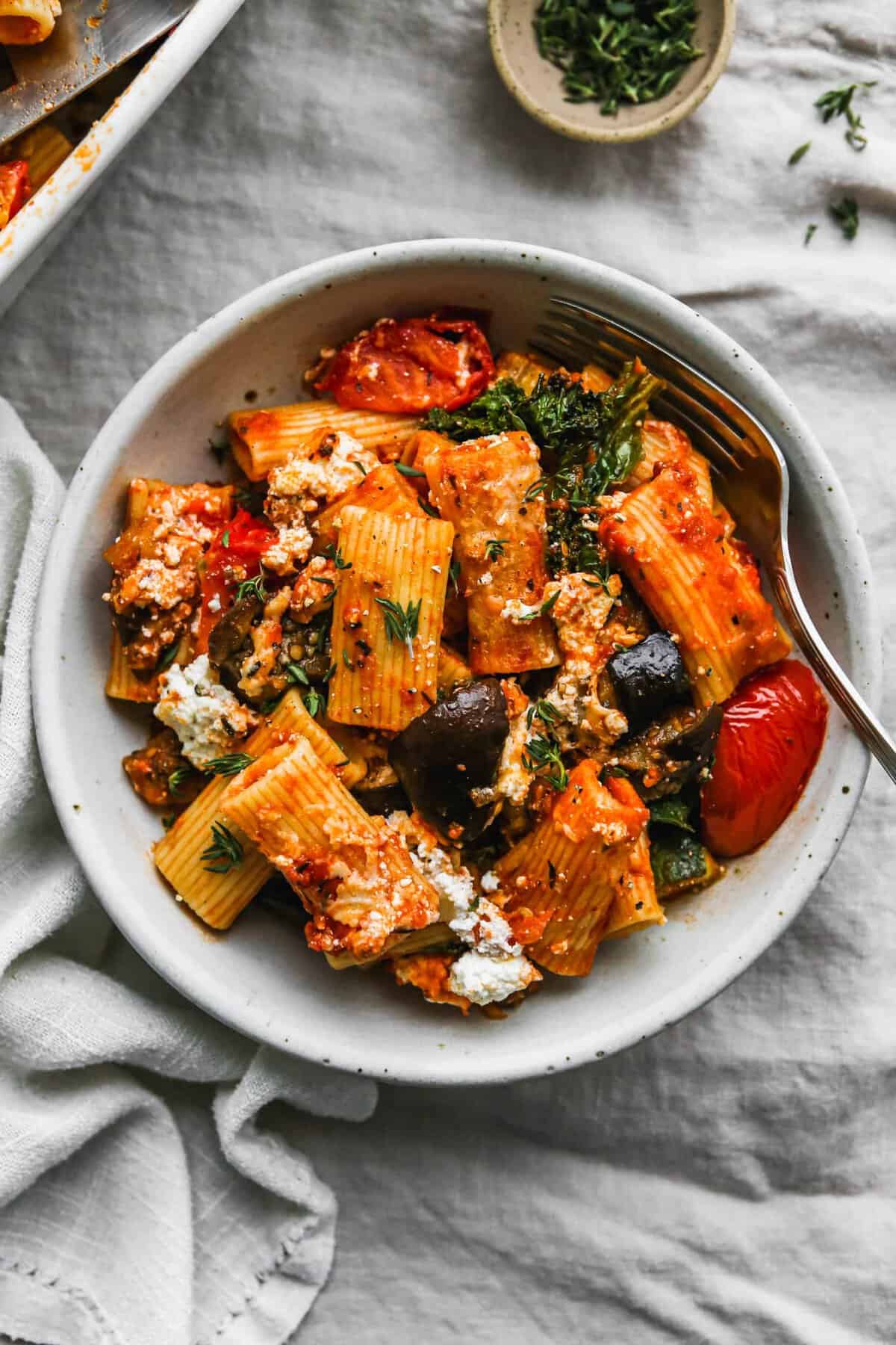 Overhead shot of eggplant pasta bake with tomato and zucchini from Walder Wellness with tomato, cheese and olives.