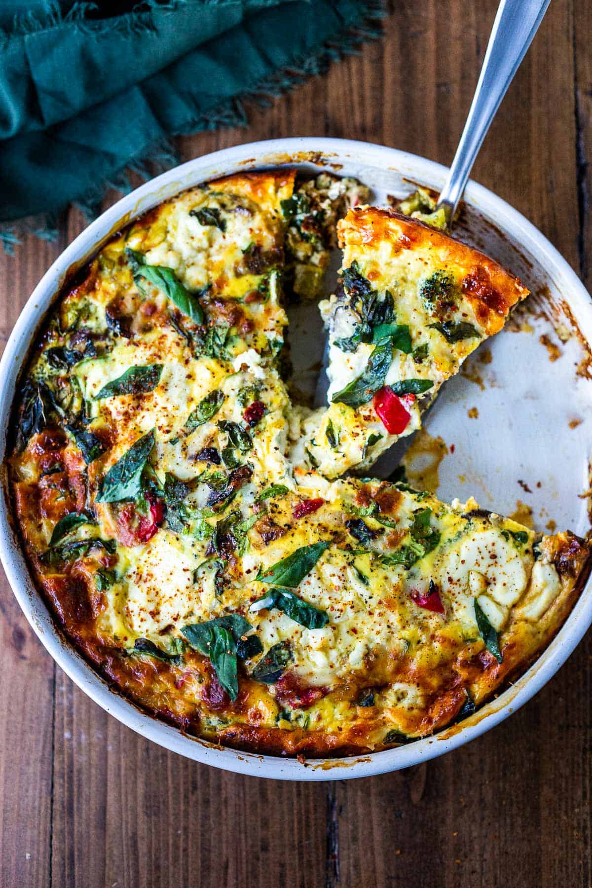 Overhead shot of a pan of frittata with veggies in it.