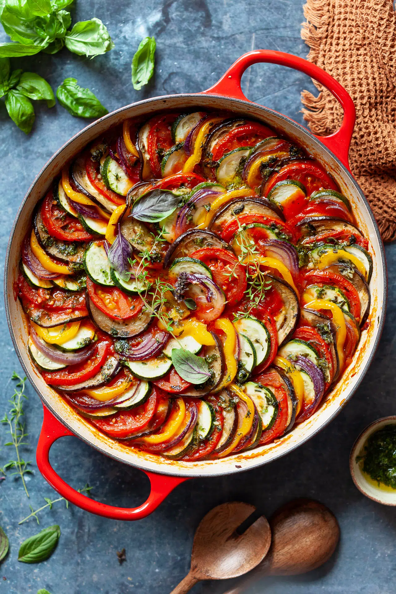 Overhead shot of ratatouille in a red cast-iron pan.
