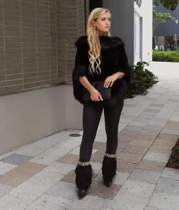 SkyStruk model with coat wearing the Black fur stiletto boot