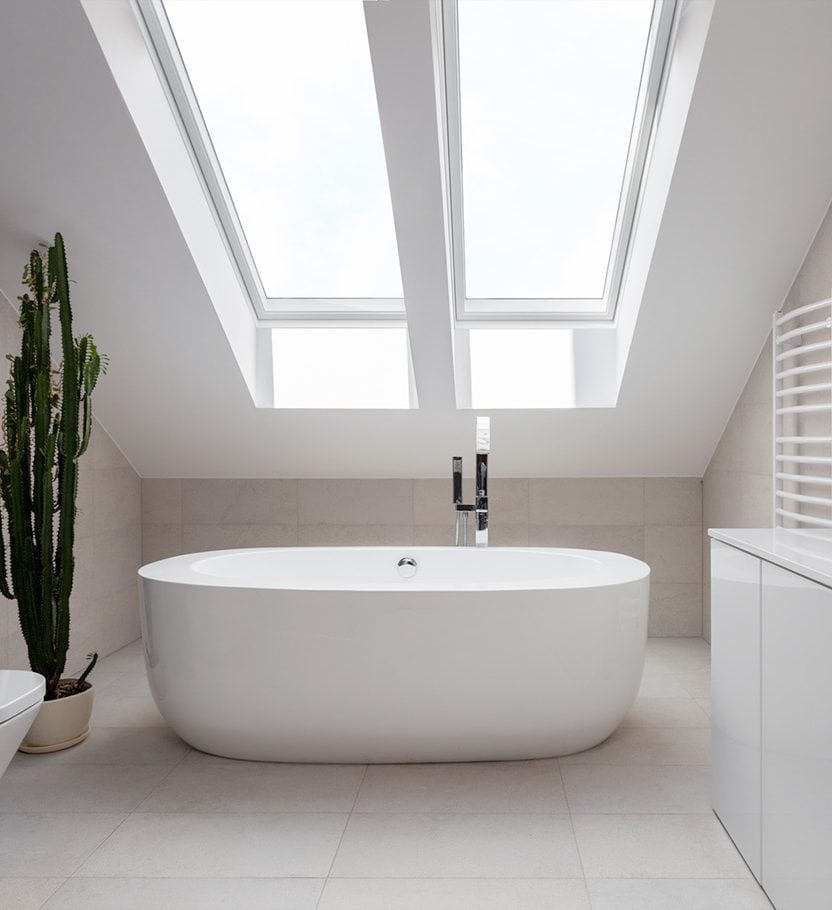 Bathtub underneath skylights