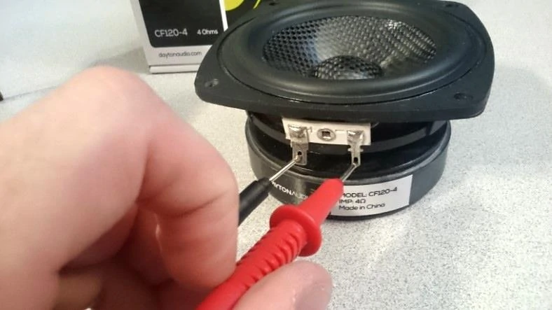 Example image showing how to use multimeter probes on a speaker