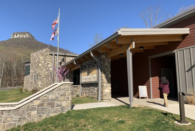 Exterior view of Pilot Mountain State Park Visitor Center with surrounding greenery.