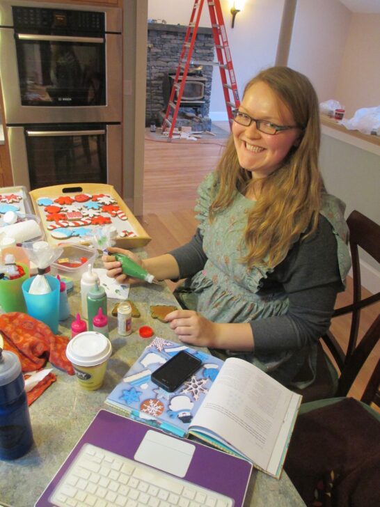 photo of Grace Gaylord aka The Graceful Baker decorating cookies with royal icing