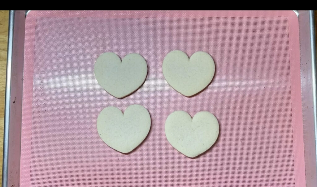 Fresh baked sugar cookies on a perforated baking mat