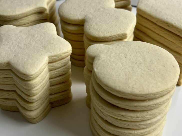 picture of stacked sugar cookies in the shape of ornaments