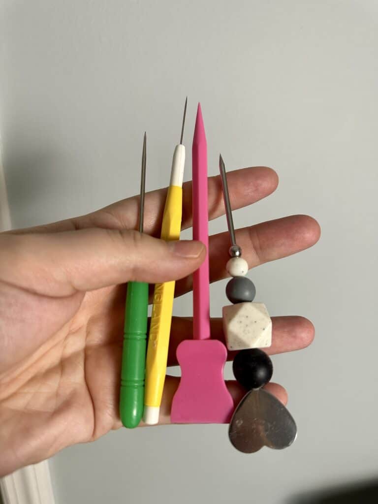 picture of 4 different types of scribes using when working with royal icing 