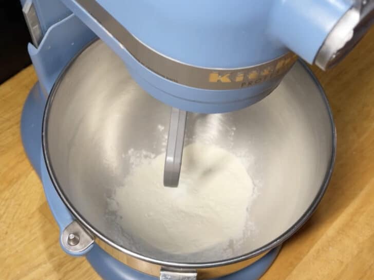photo of 45 grams of meringue powder added to mixing bowl for royal icing recipe with meringue powder
