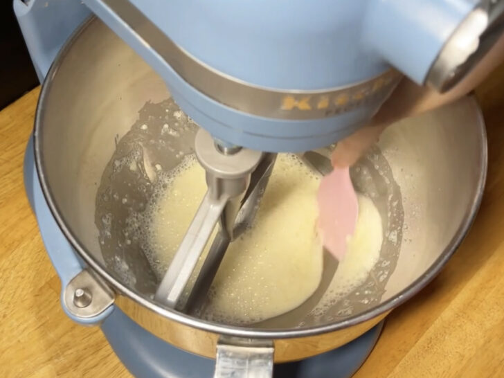photo of scraping sides of mixing bowl with lemon juice and meringue powder for royal icing recipe with meringue powder